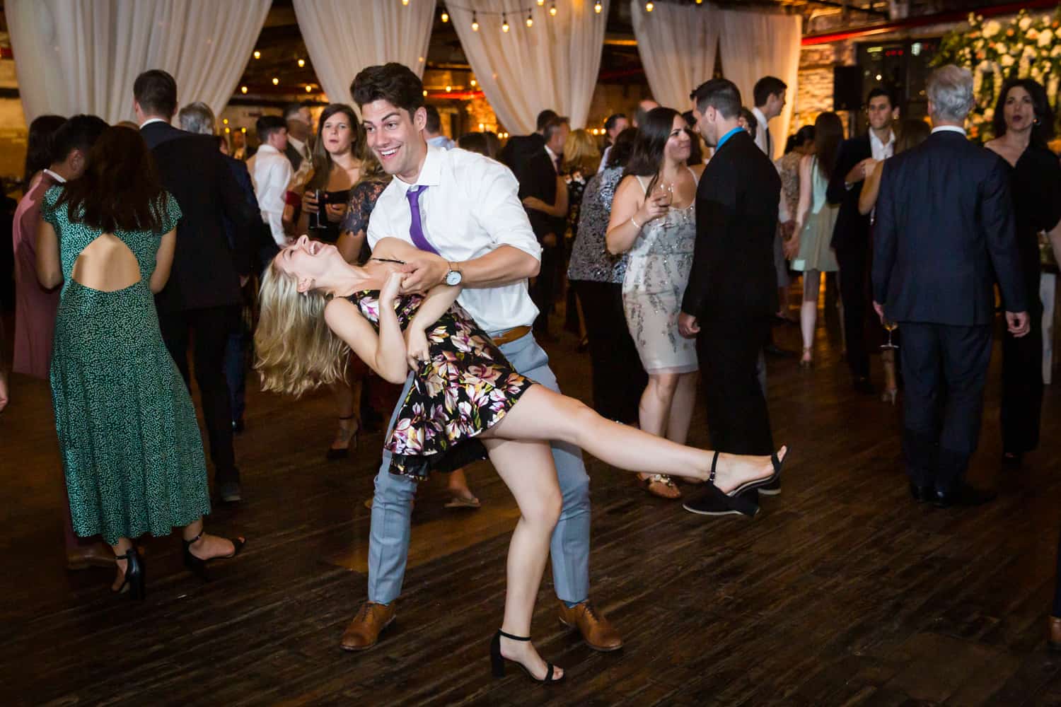 Greenpoint Loft wedding photos of man dipping woman on dance floor