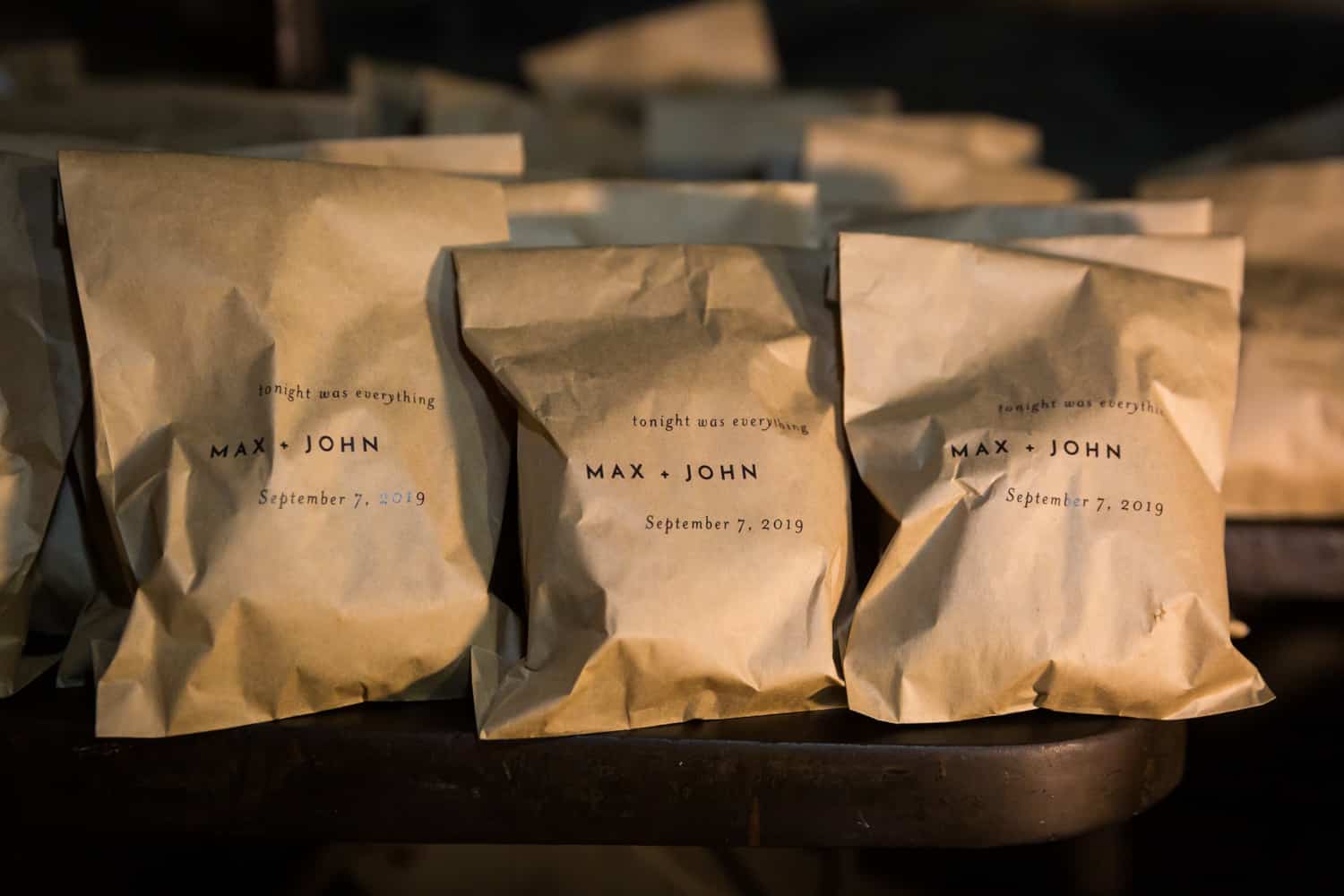 Guest favor brown paper bags with names of grooms on front