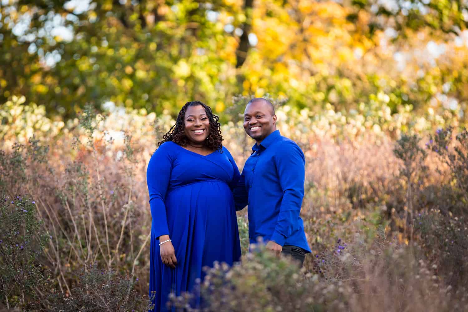 African American couple standing in Forest Park for an article on maternity photo shoot ideas