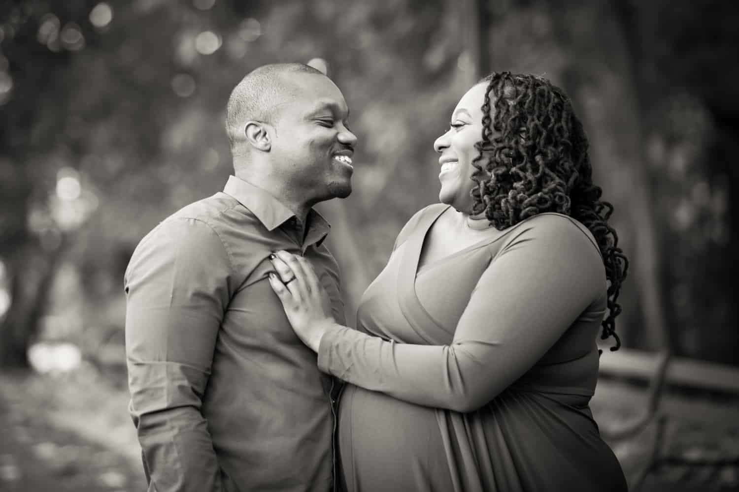 Black and white photo of African American couple laughing in Forest Park