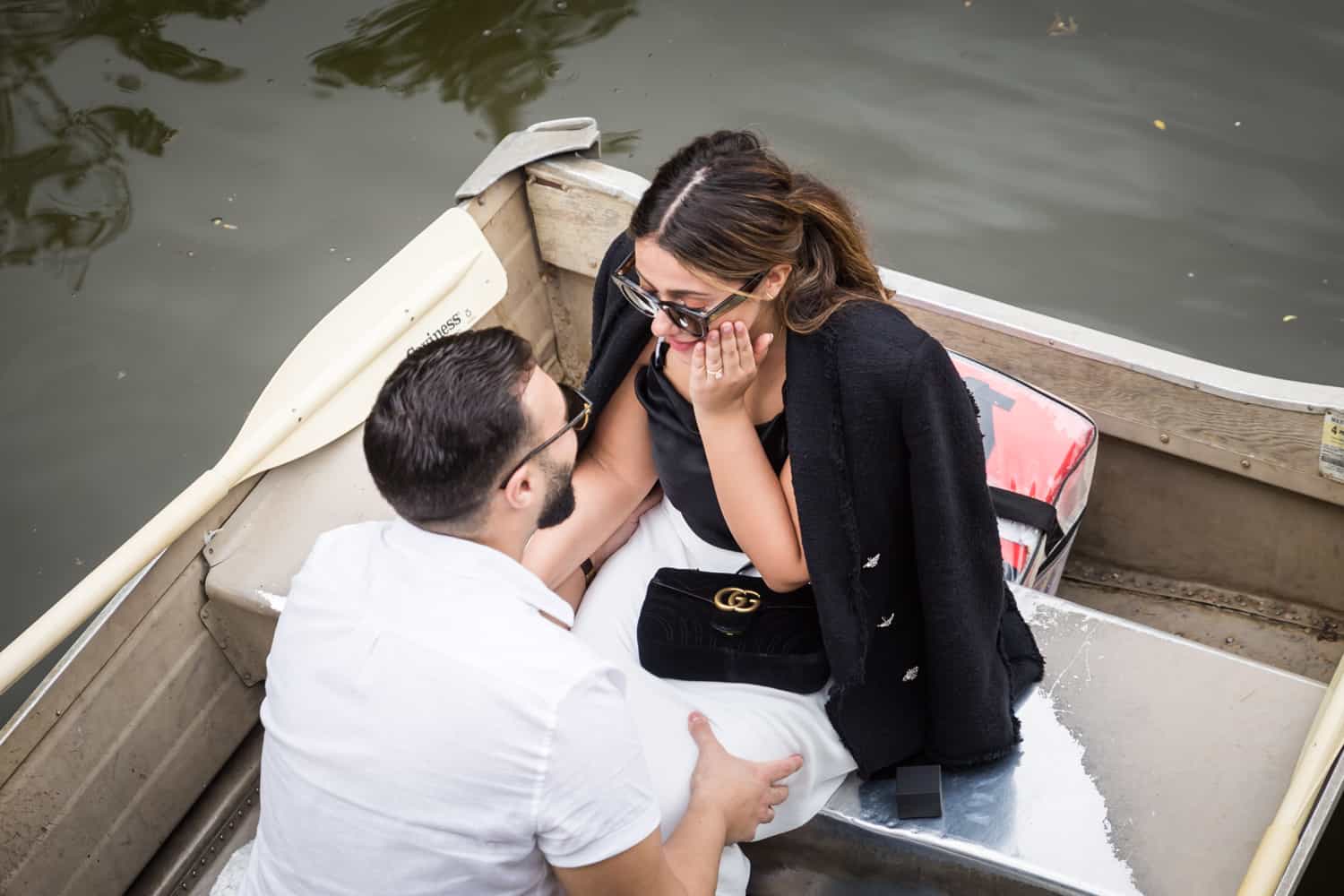 Overhead shot of man and woman in boat at a surprise proposal on Central Park Lake