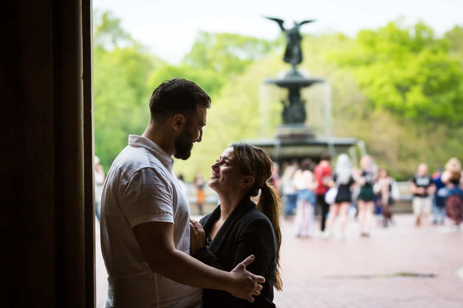 Couple standing in archway leading to Bethesda Fountain