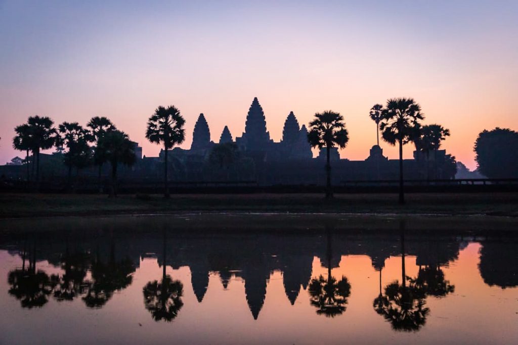 Angkor Wat reflected in water at sunrise