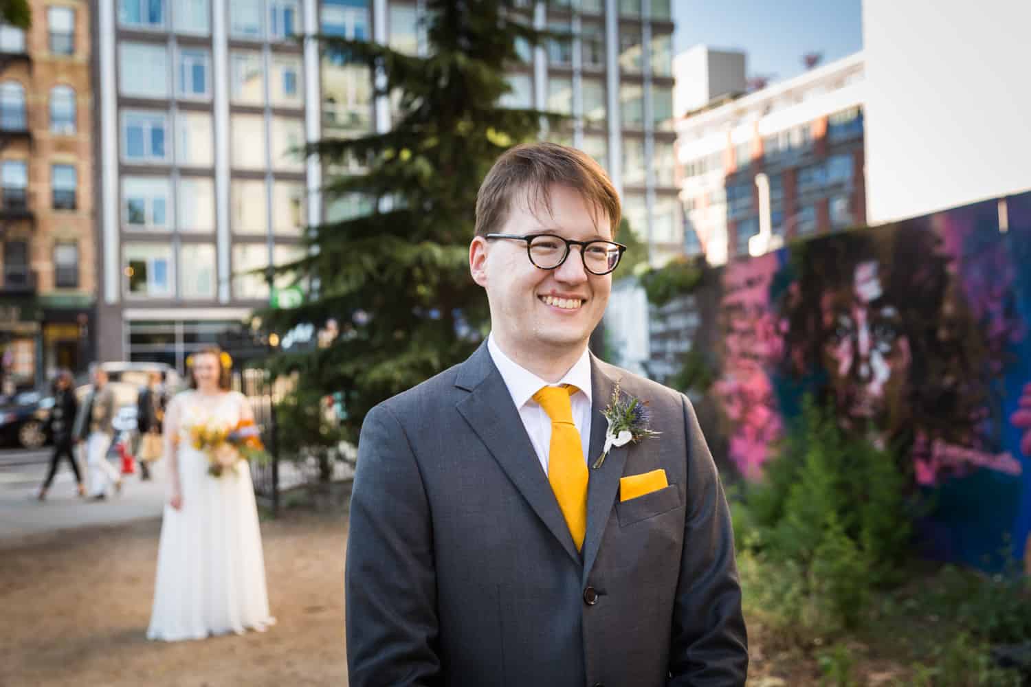 Groom waiting for first look to begin with bride