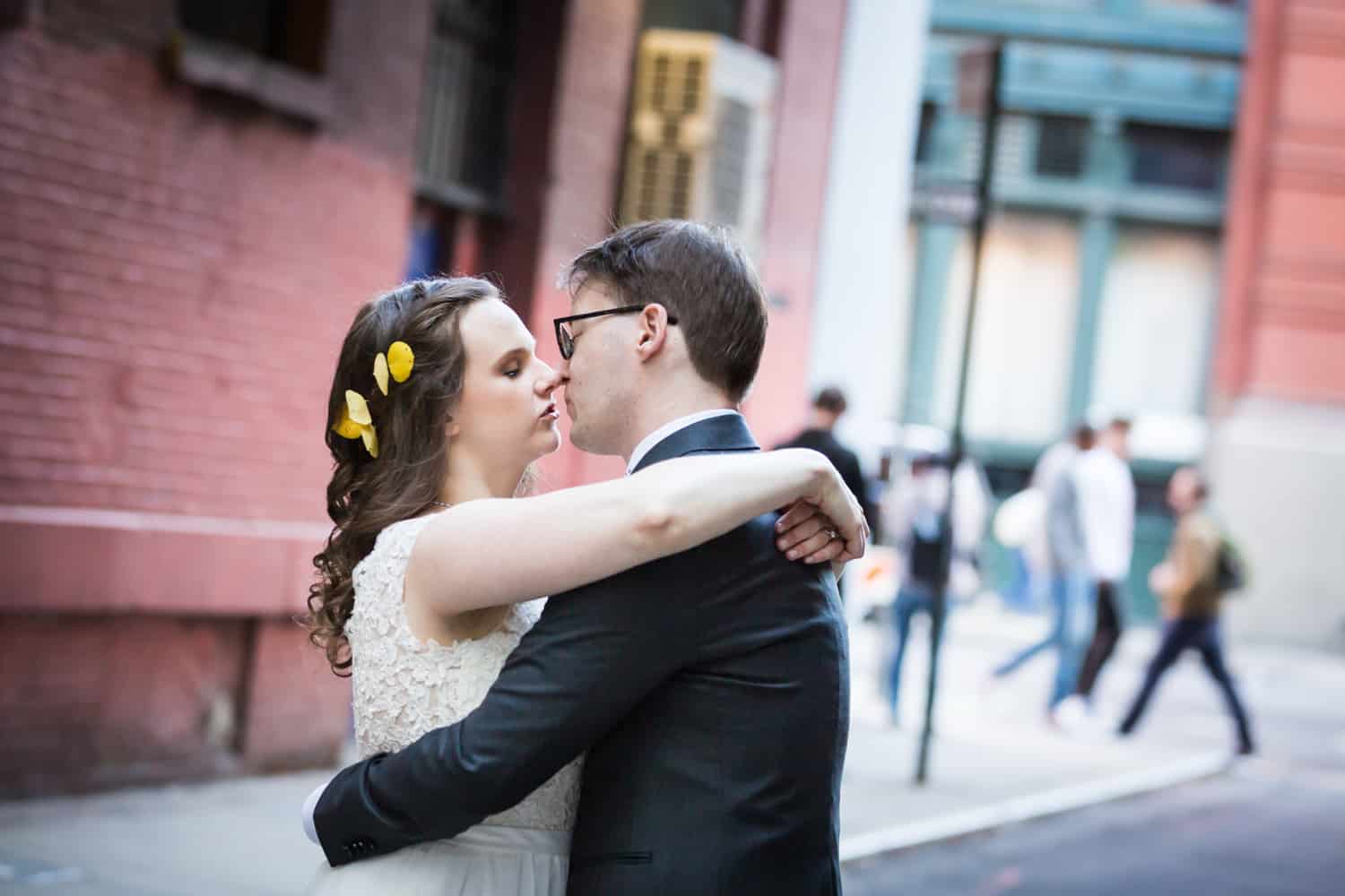 Bride and groom about to kiss in alleyway for an article on Covid-19 wedding planning