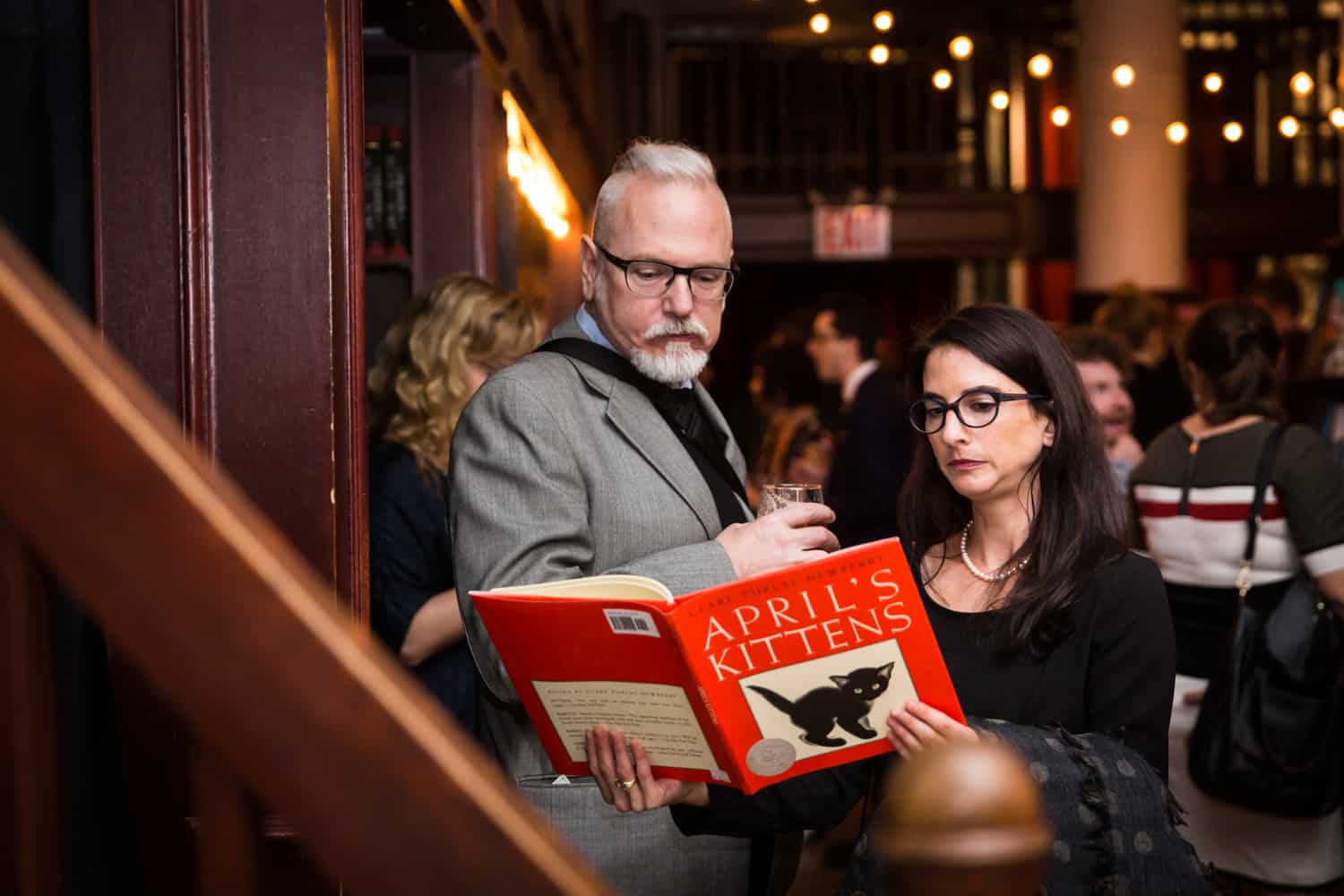 Guests reading from a book at a Housing Works Bookstore Cafe wedding