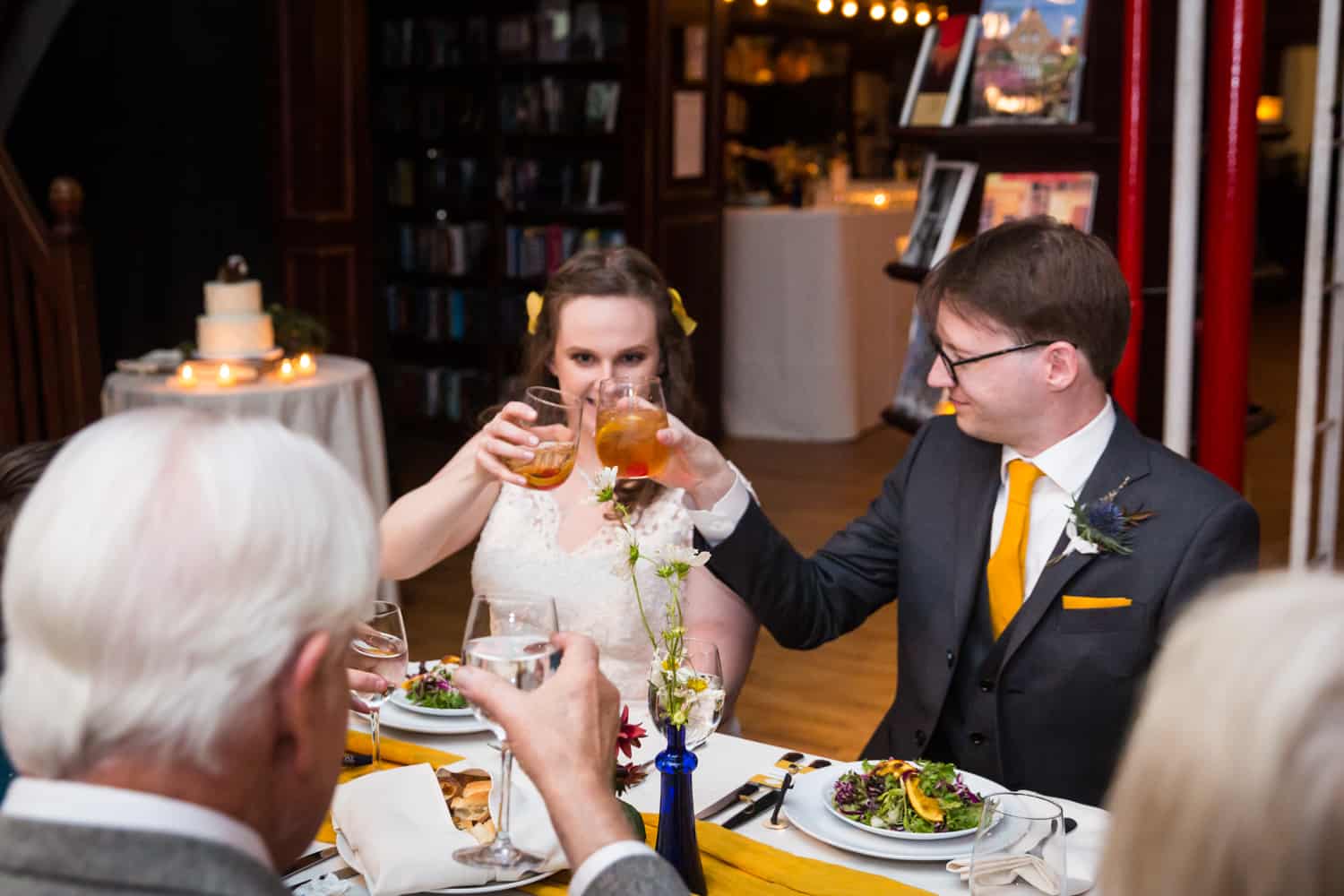 Bride and groom toasting glasses for an article on Covid-19 wedding planning