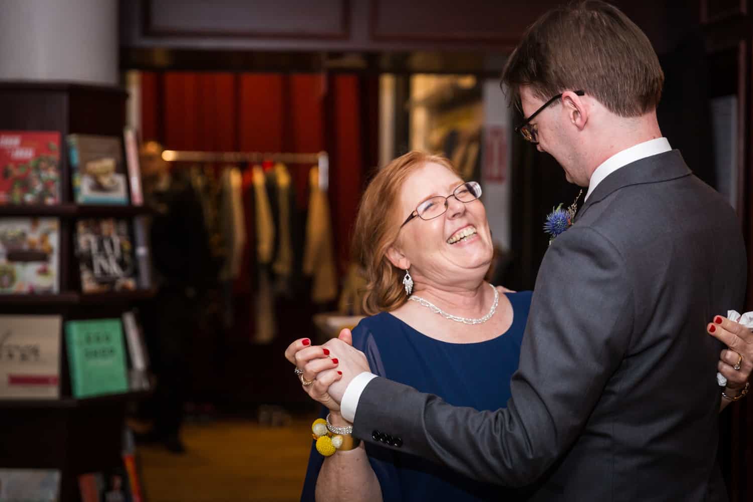 Groom dancing with mother at a Housing Works Bookstore Cafe wedding