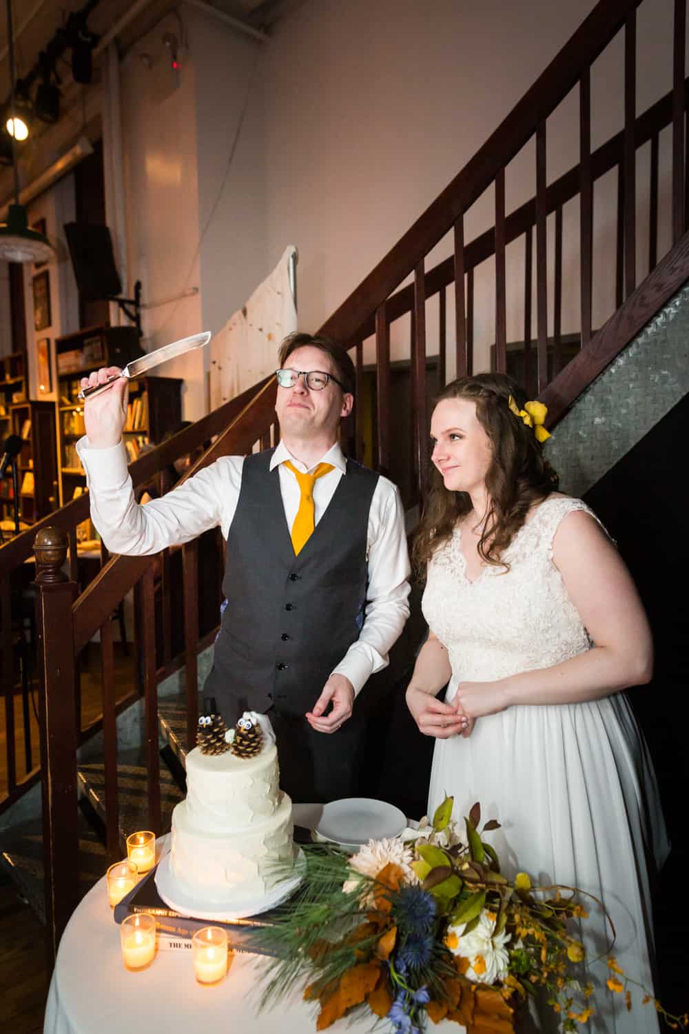 Bride and groom about to cut cake at a Housing Works Bookstore Cafe wedding