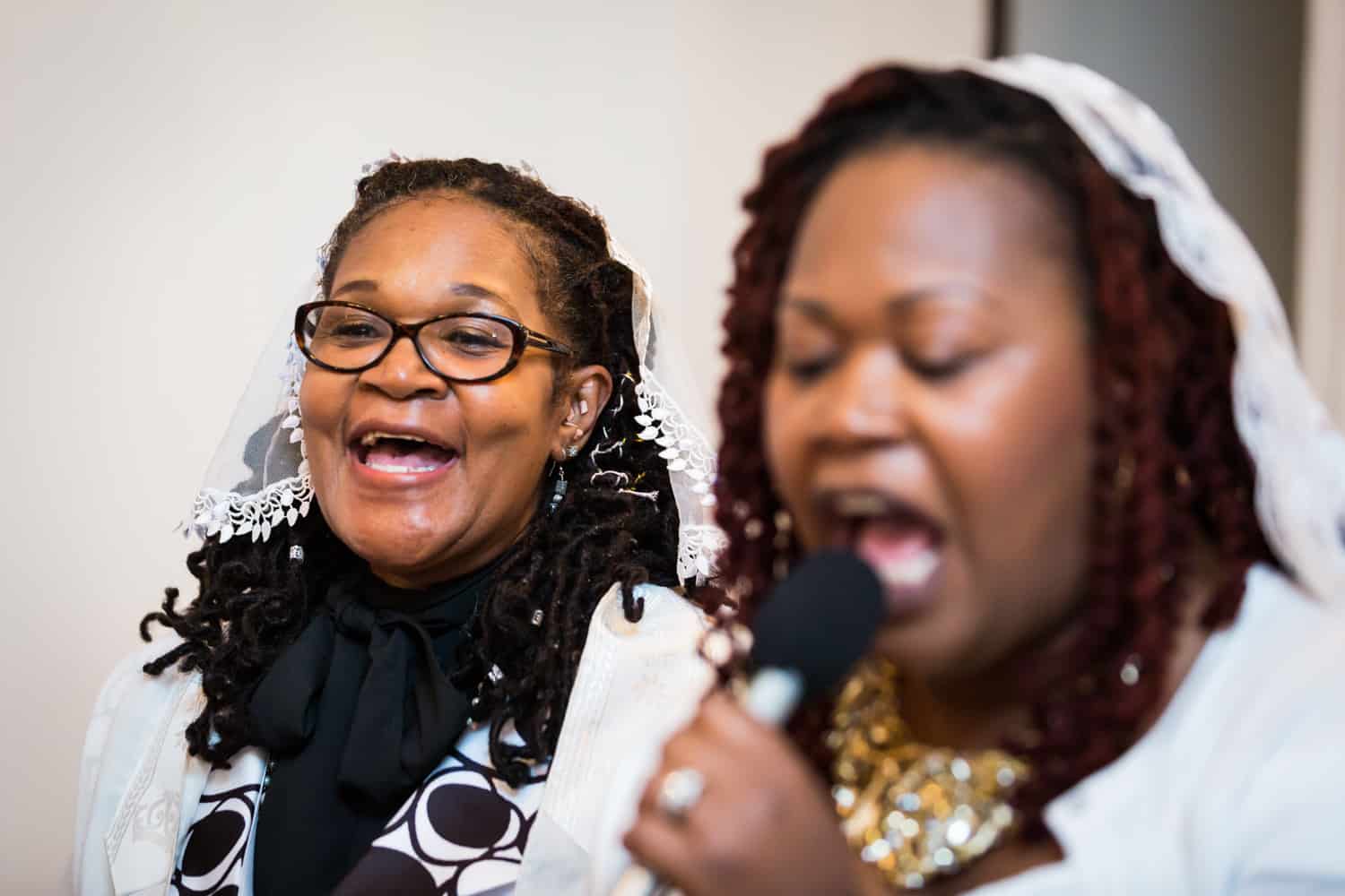 Two African American women singing during Jamaica christening