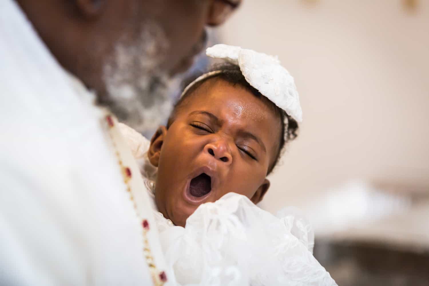 African American baby yawning during Jamaica christening