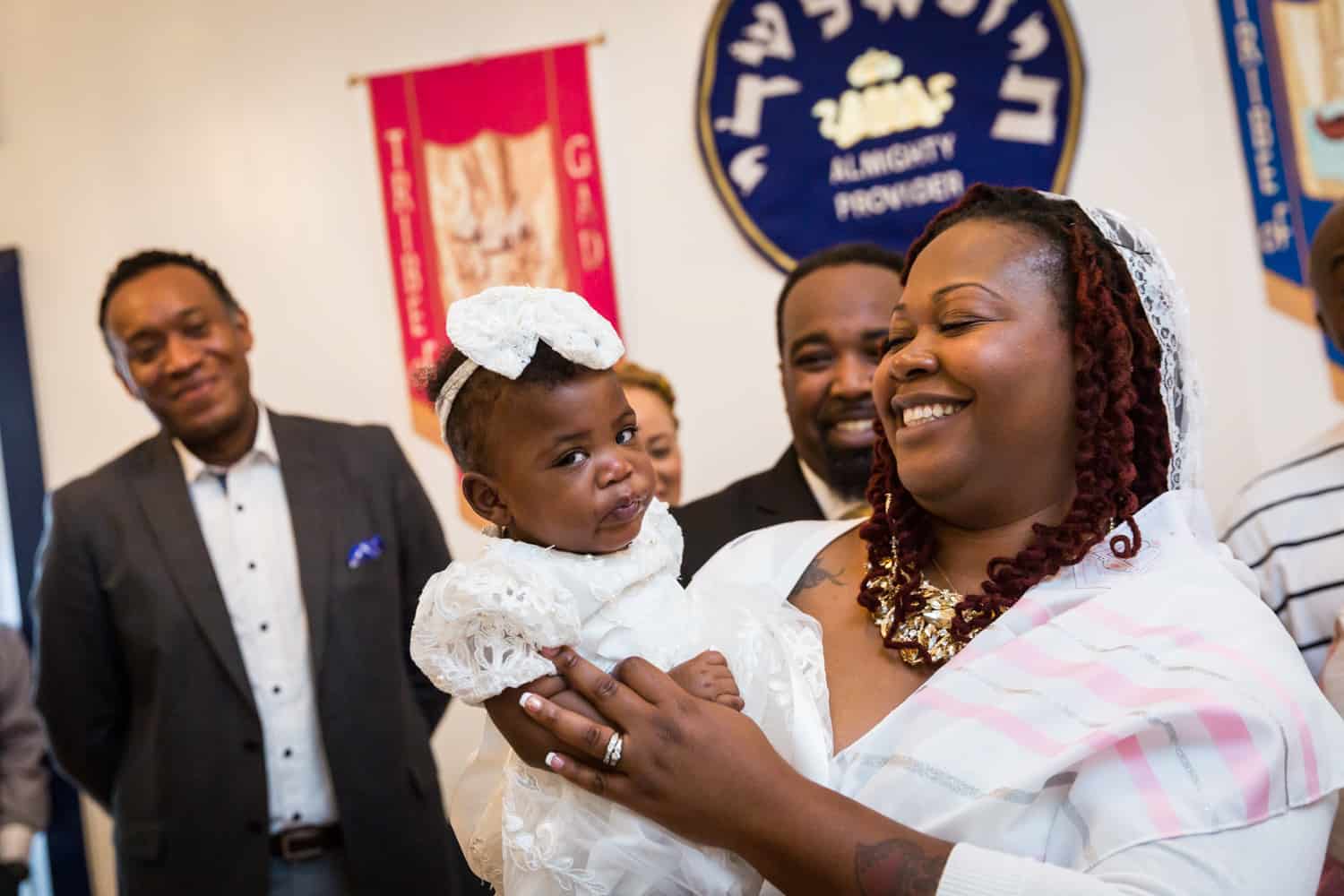 Baby making funny face during Jamaica christening