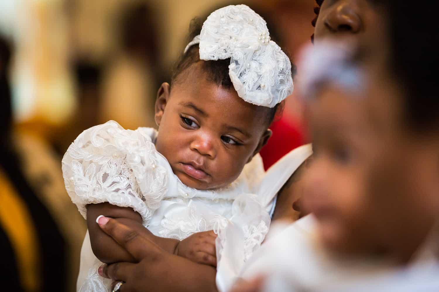 African American little girl wearing white dress and white bow