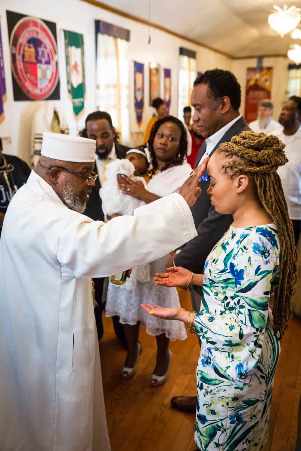 Pastor blessing family members during Jamaica christening