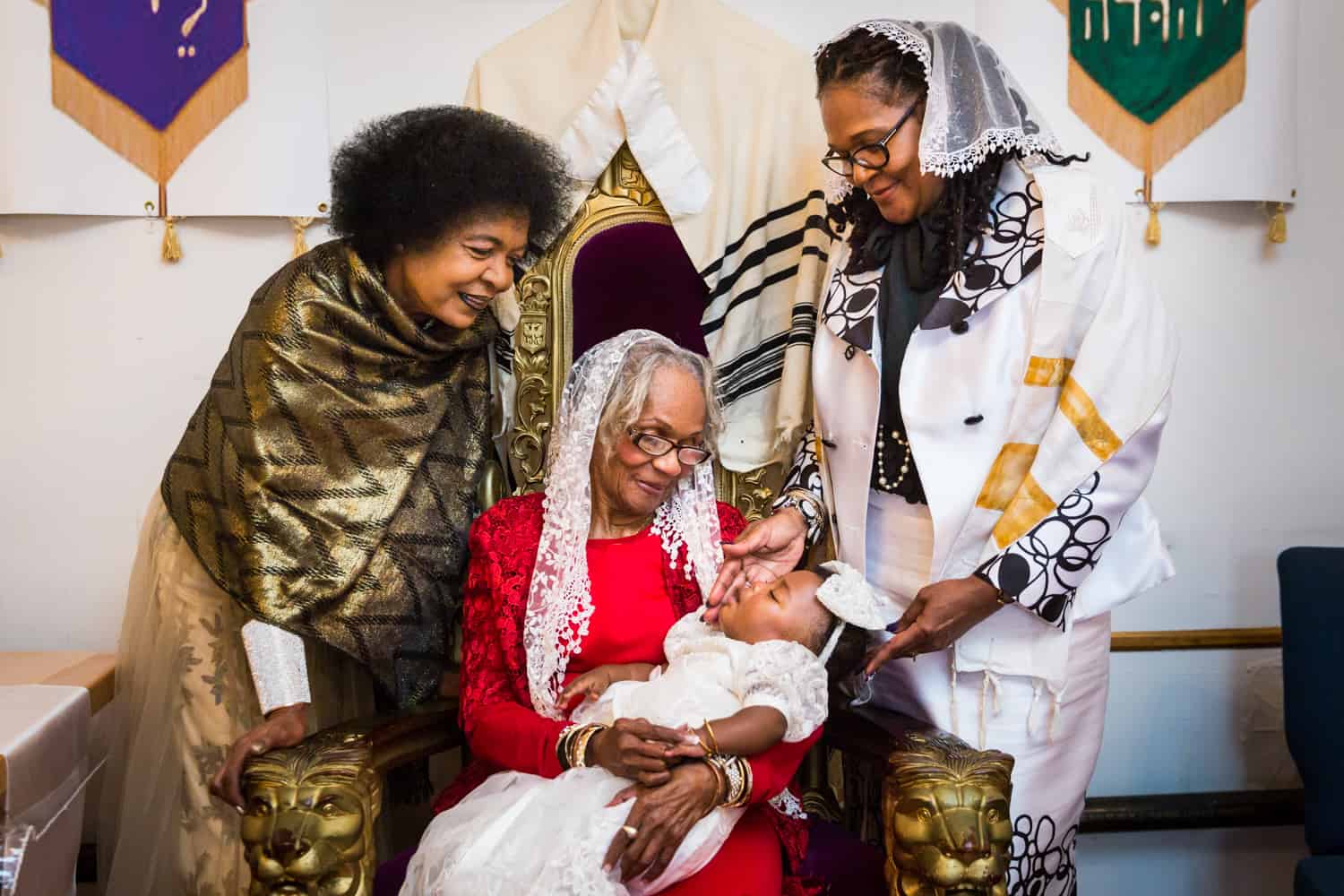 Grandmother holding baby surrounded by two older female family members