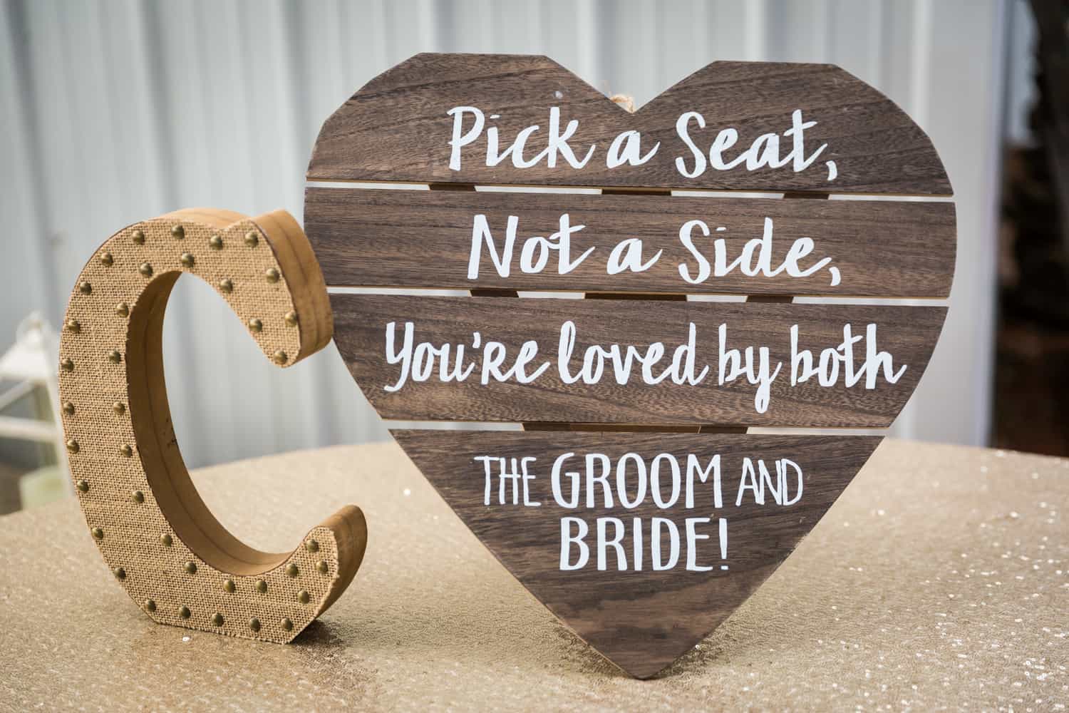 Seating sign for guests on heart-shaped wood