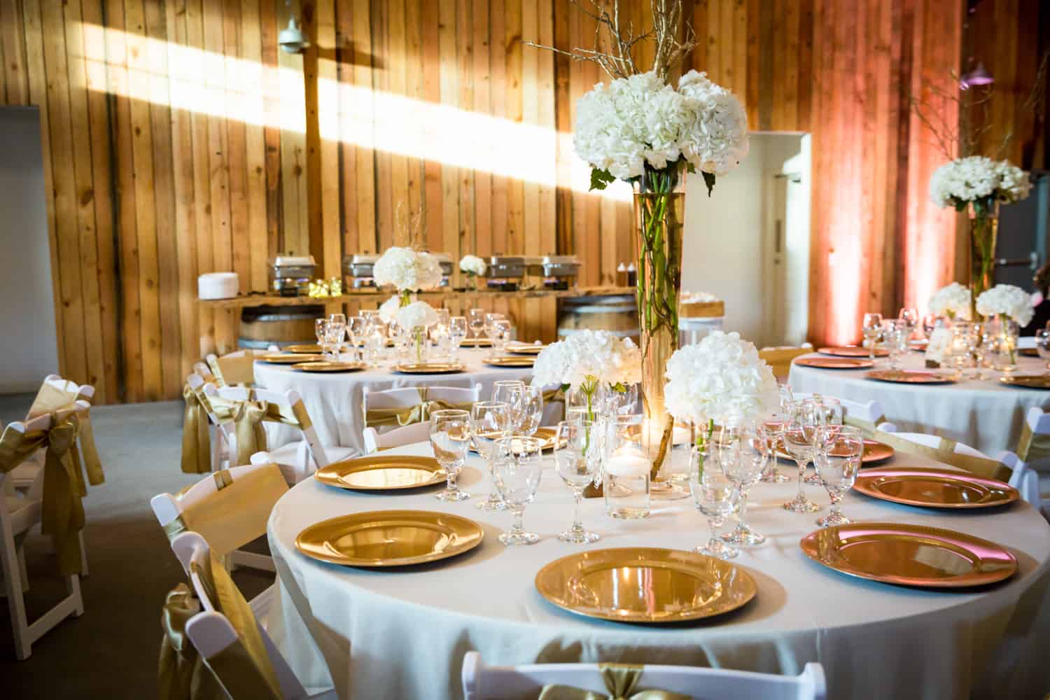 Place setting with gold chargers for an article on wedding cost cutting tips