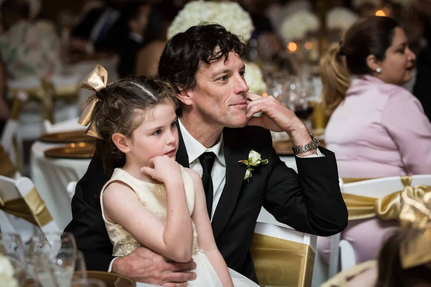 Man and little girl listening to speeches for an article on wedding cost cutting tips