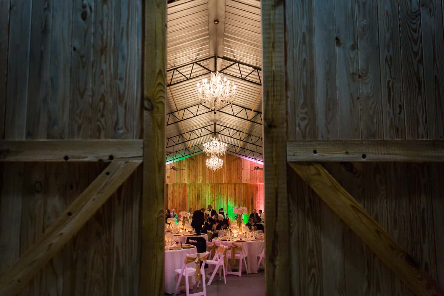 View through doorway of Florida wedding reception in barn