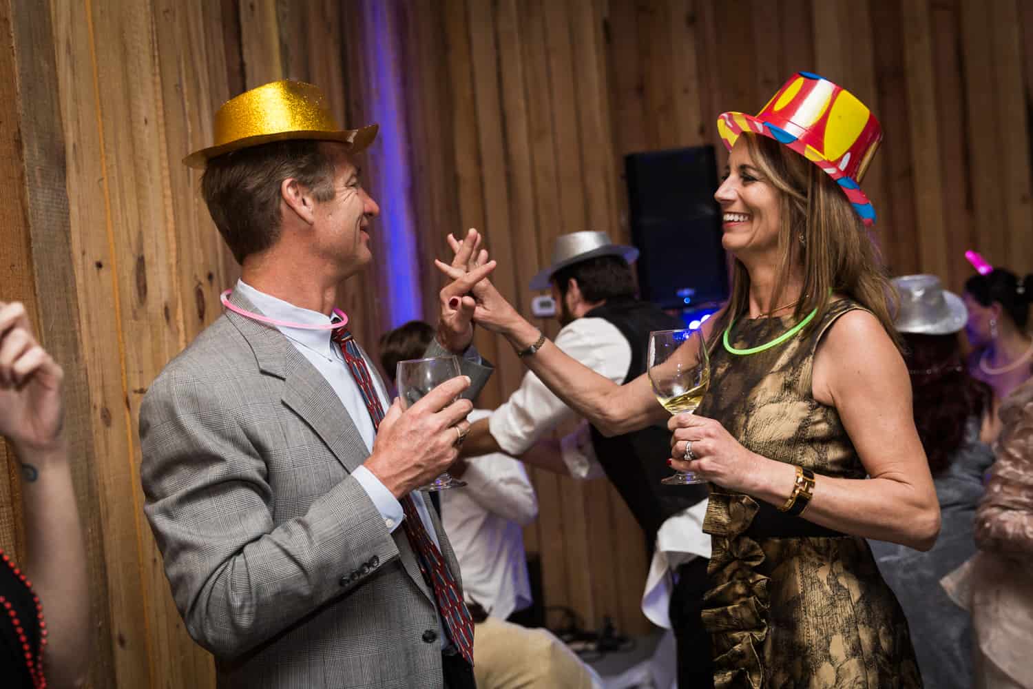 Couple wearing party hats and dancing during Florida wedding reception