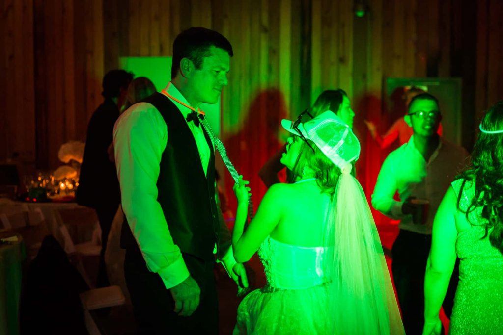 Bride and groom in green light dancing