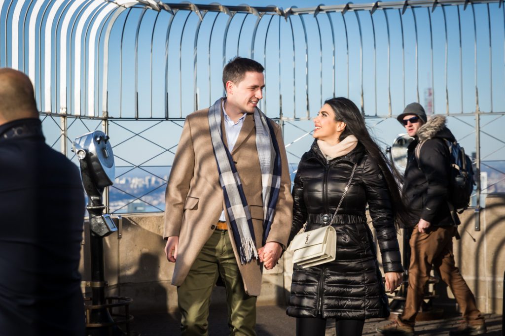 Couple walking on 86th floor viewing platform of Empire State Building