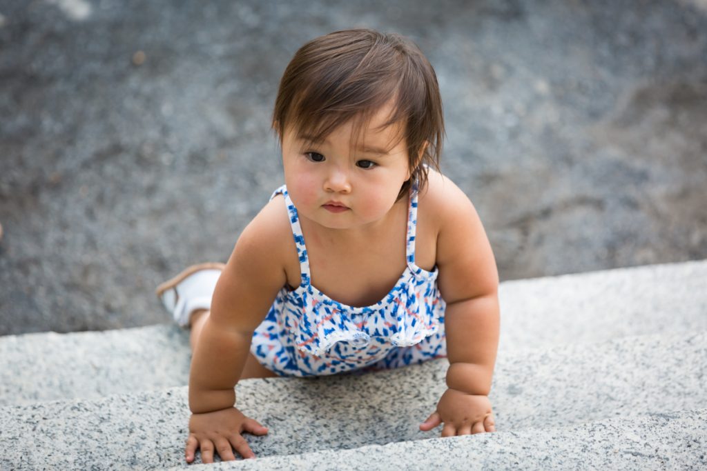 Baby girl crawling up steps of Belvedere Castle