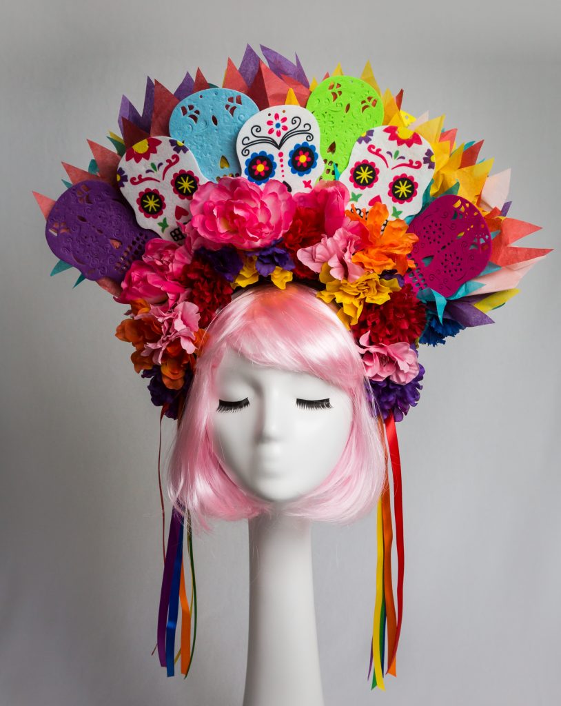 Pink haired mannequin wearing colorful floral Day of the Dead headband