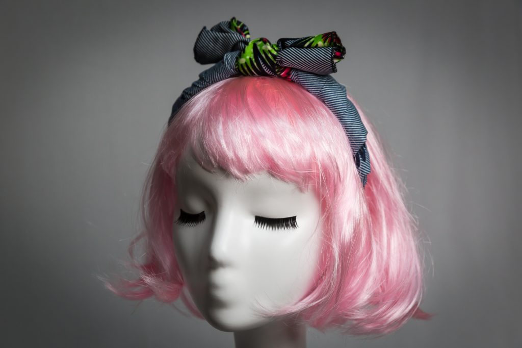 Pink haired mannequin wearing African wax cloth fabric headband