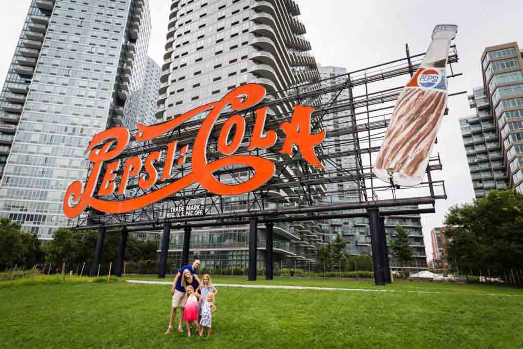 Family in front of Pepsi Cola sign during a Gantry Plaza family portrait session