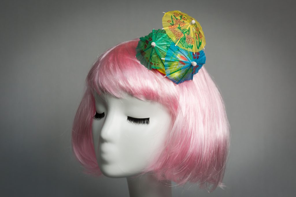 Pink haired mannequin wearing cocktail umbrella fascinator by Chapeau A Go Go boutique