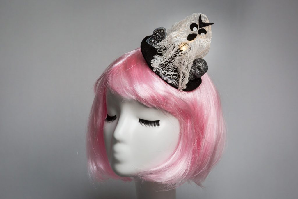 Pink haired mannequin wearing cheesecloth ghost fascinator that lights up
