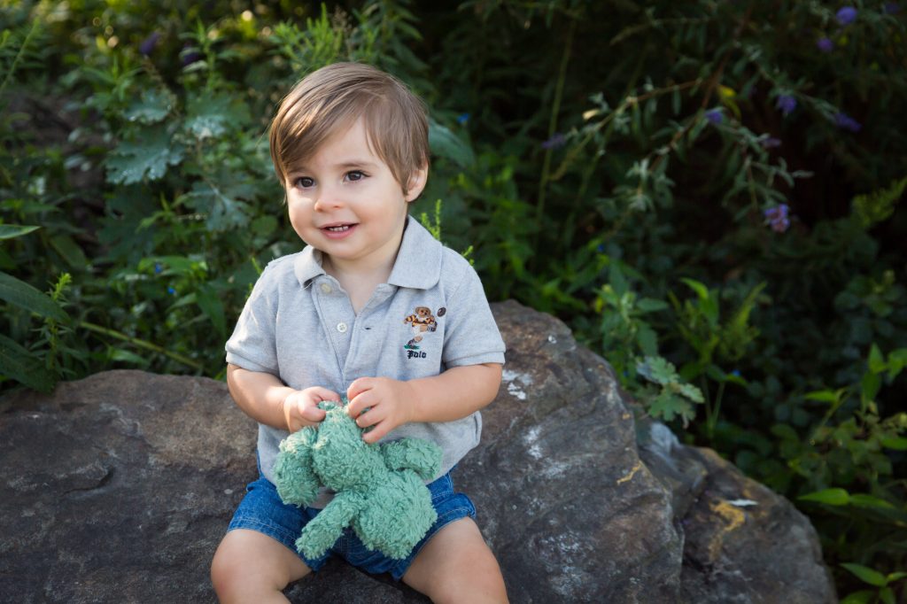 Little boy sitting on rock in Hudson River Park