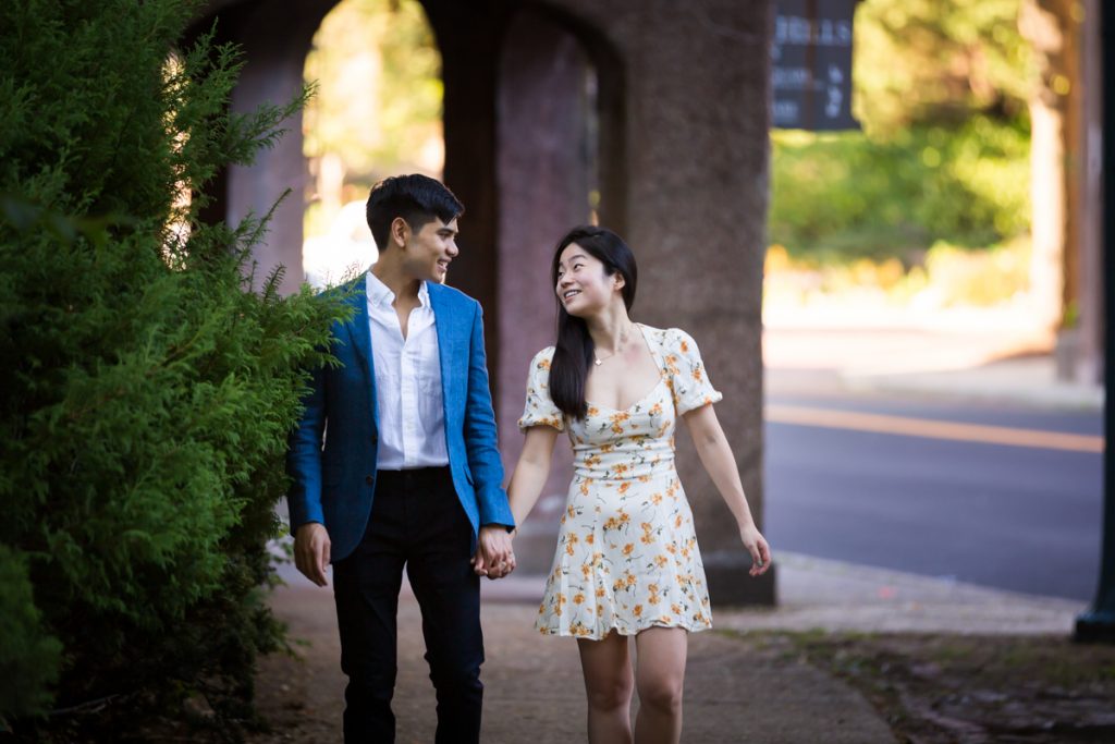Couple walking hand in hand on Greenway Terrace during Forest Hills engagement shoot
