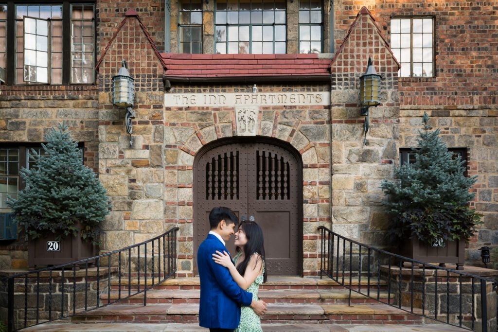 Couple hugging in front of steps of Forest Hills Inn Apartments