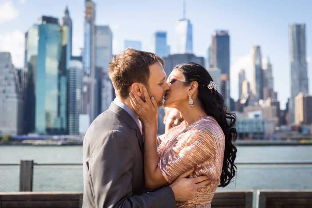 Bride and groom kissing after ceremony for an article on how to get married in Brooklyn Bridge Park