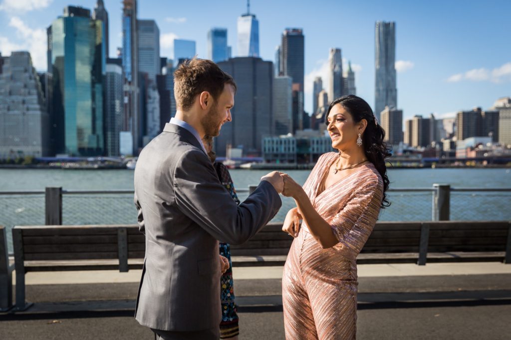 Bride and groom fist bumping for an article on how to get married in Brooklyn Bridge Park