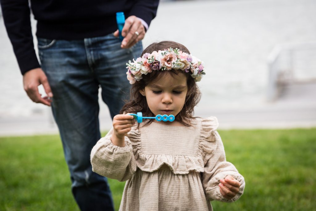 Little girl blowing bubbles in Riverside Park