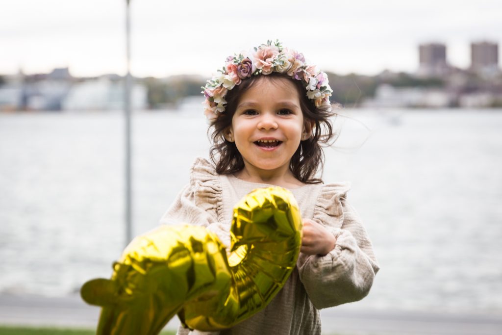Little girl holding number 2 balloon during a Riverside Park family portrait session