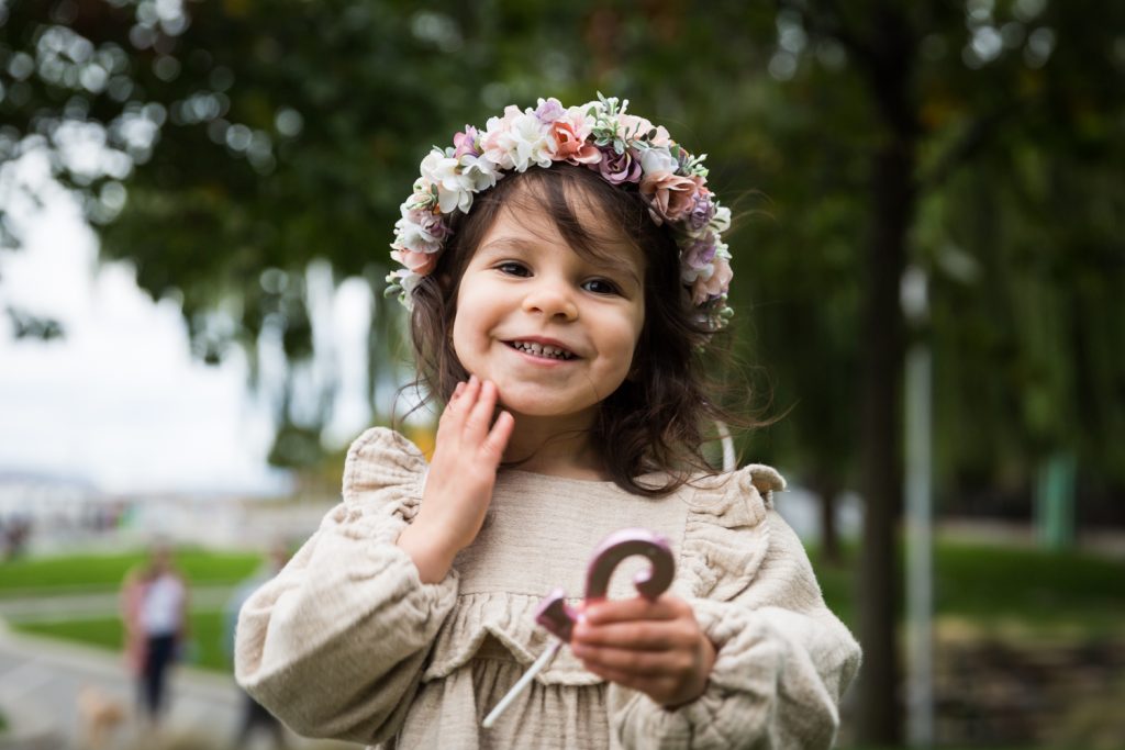 Little girl smiling and wearing flower crown
