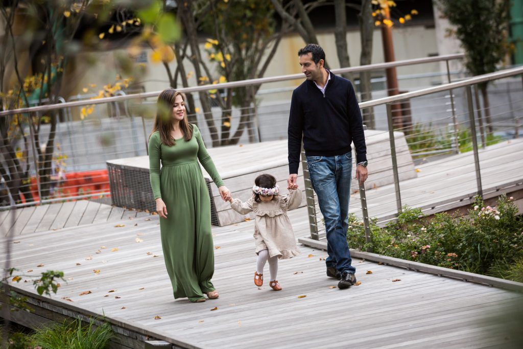 Family walking with little girl in Waterline Square Park