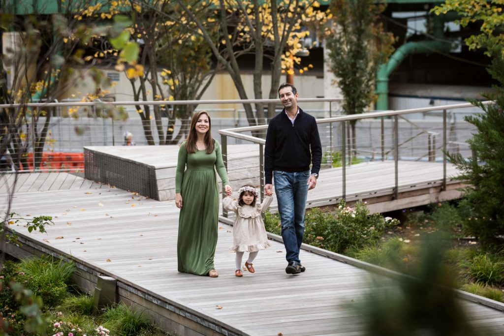 Family walking on boardwalk with little girl in Waterline Square Park