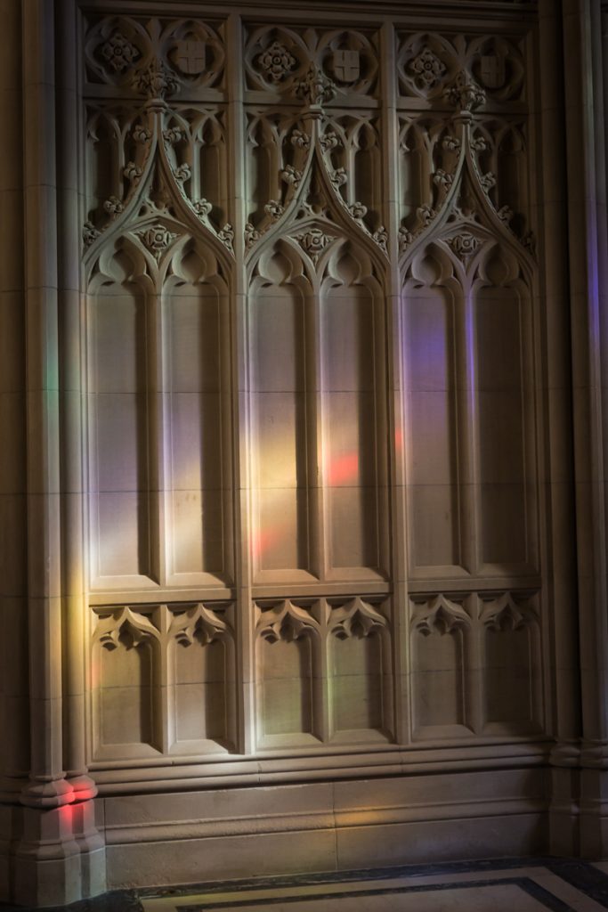 Colorful light cast on stone pillars in Green-Wood Cemetery historic chapel