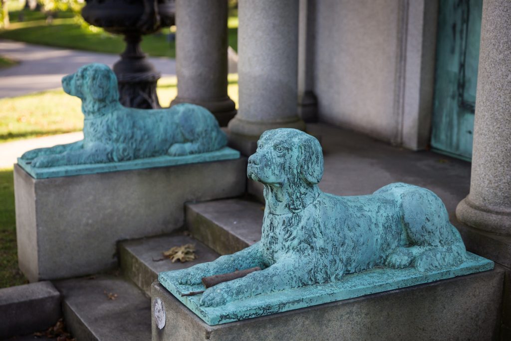 Dog statues in front of mausoleum at Green-Wood Cemetery