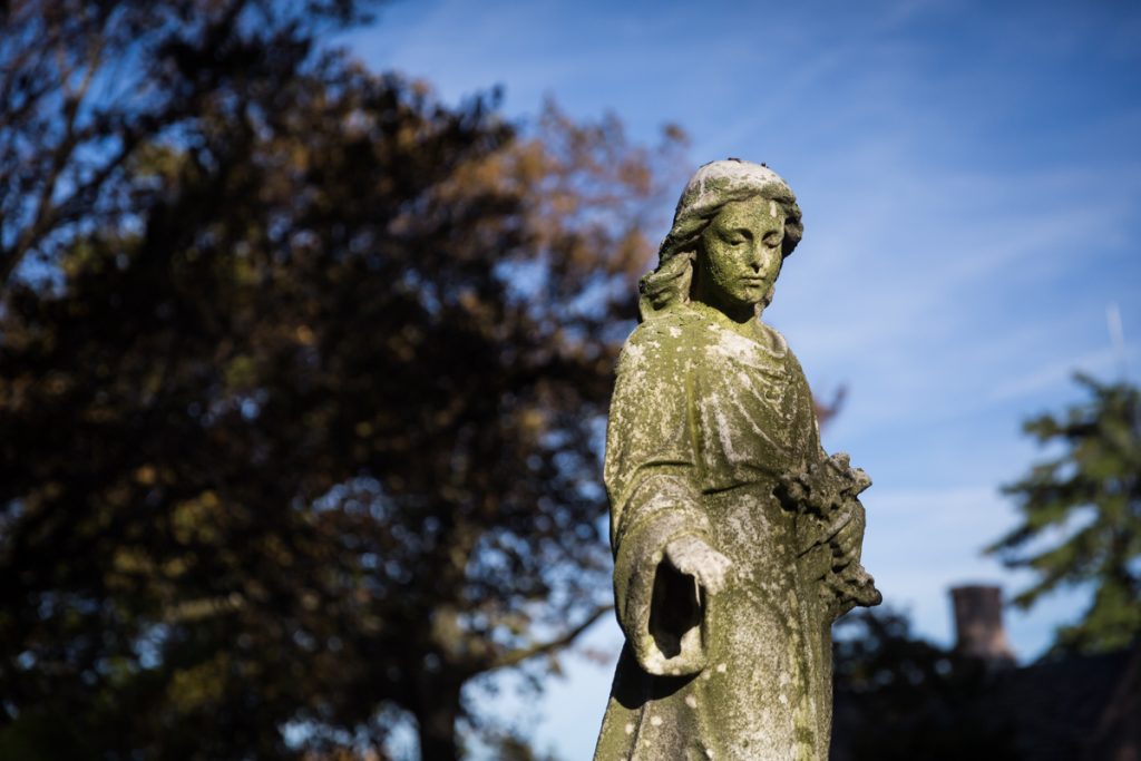 Grave statue with arm outstretched at Green-Wood Cemetery