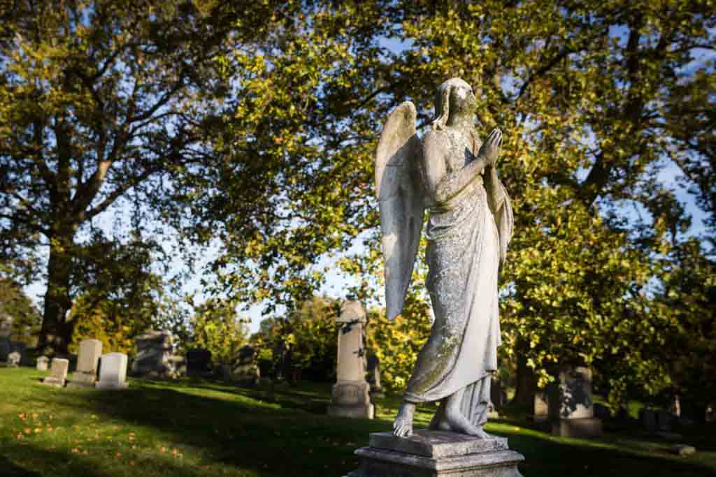 Praying angel statue for an article on visiting Green-Wood Cemetery