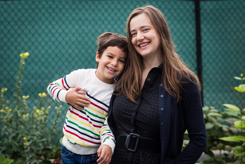 Mom and son in front of fence during a Gowanus family portrait session