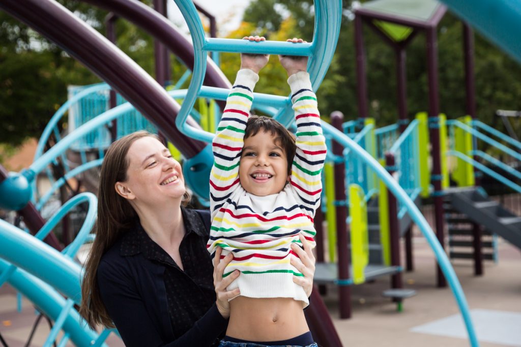 Mother helping boy climb at an Ennis Playground family portrait session