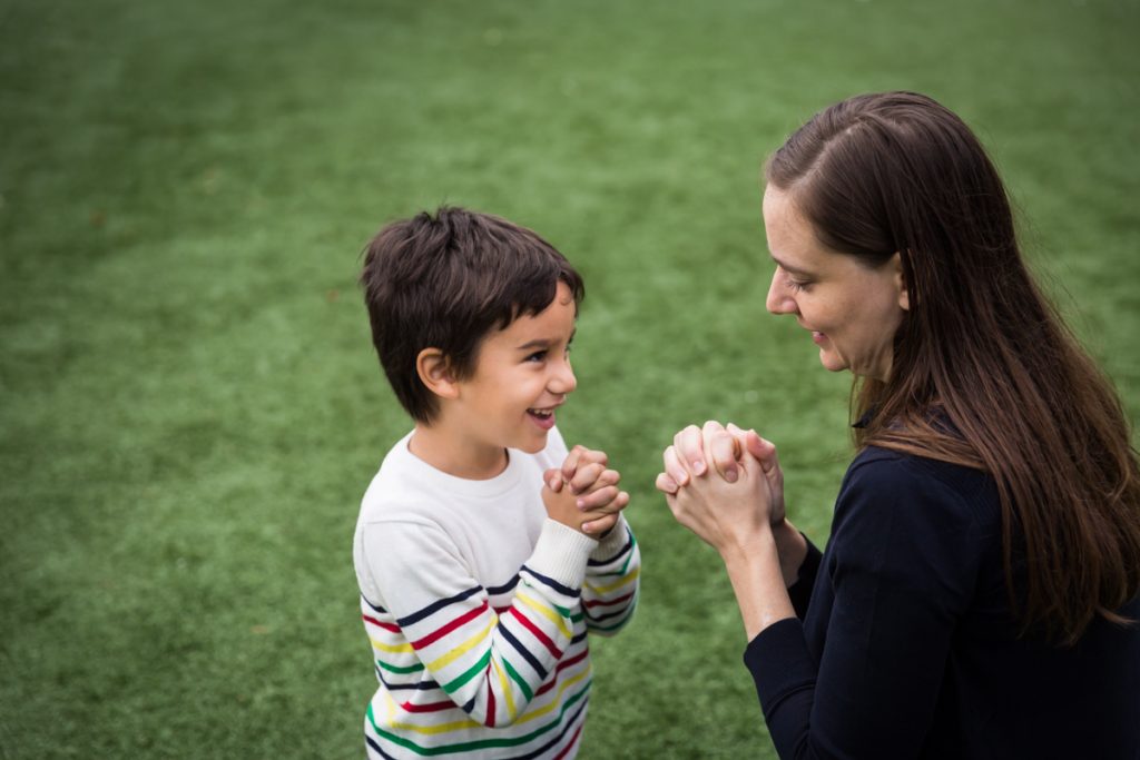 Mother and son playing with closed fists at an Ennis Playground family portrait session