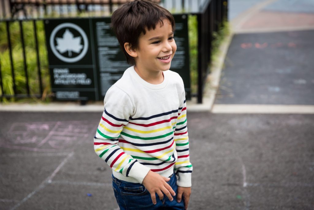 Boy wearing colored strip shirt at an Ennis Playground family portrait session